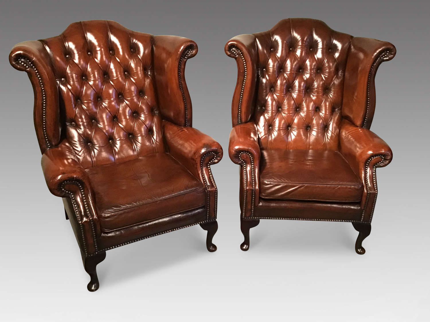 Pair of leather wing chairs