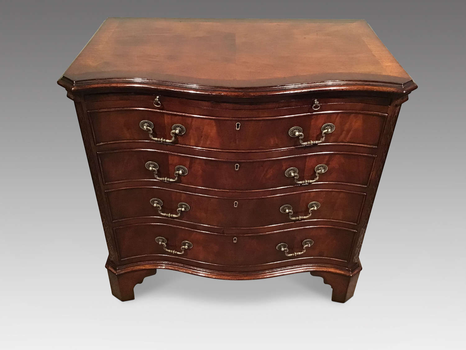 Antique mahogany serpentine chest