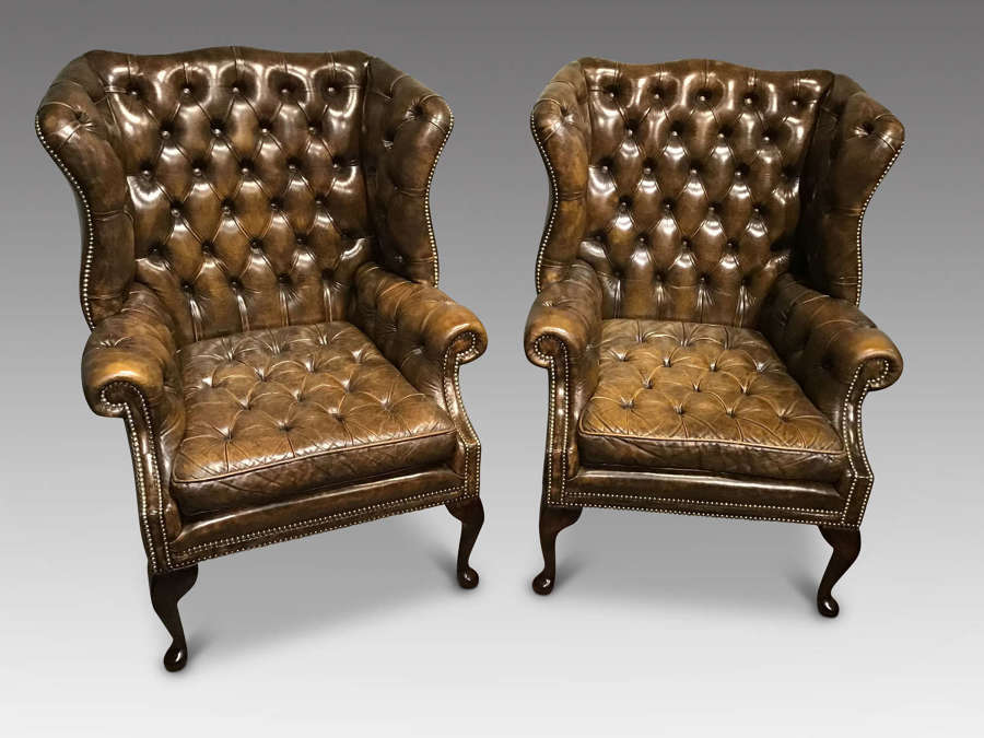 Pair of antique leather wing chairs