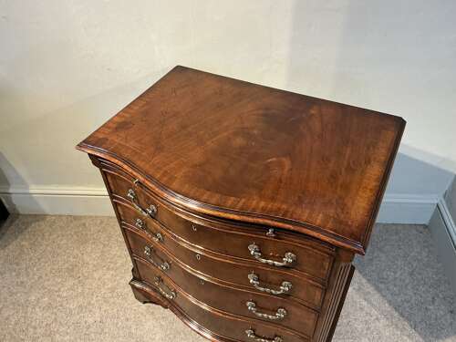 Antique mahogany serpentine chest of drawers.