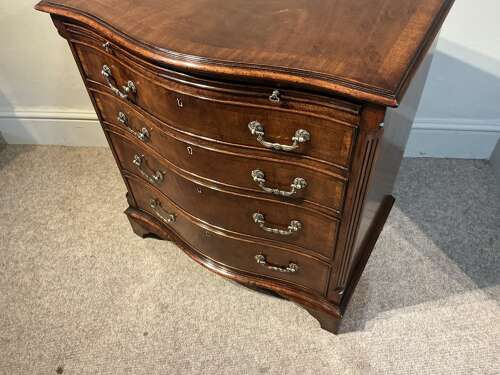 Antique mahogany serpentine chest of drawers.