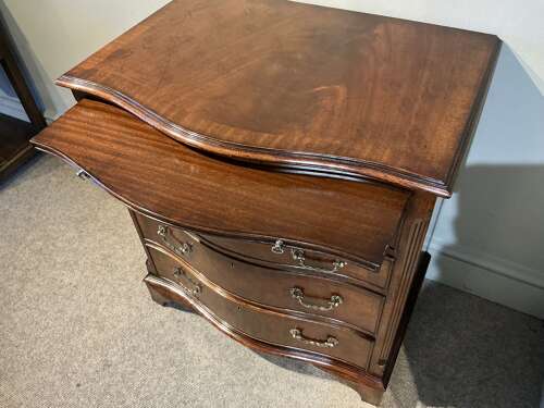 Antique mahogany serpentine chest of drawers.