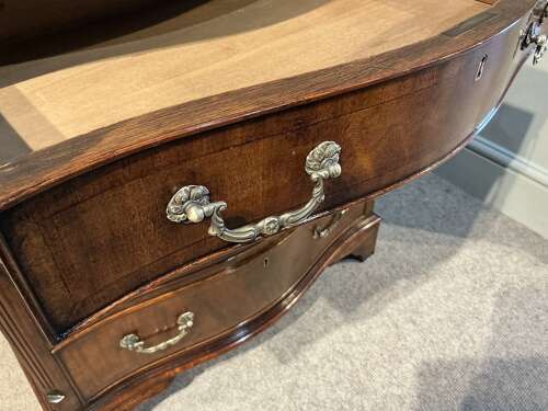 Antique mahogany serpentine chest of drawers.